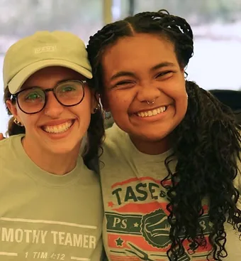 2 high school aged girls smiling for camera