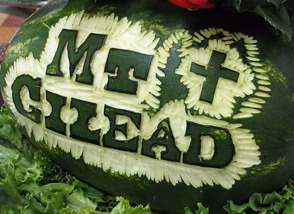 GuestRetreats-feature-watermelon Watermelon carved with bold letters spelling 'MT GLEAD' and decorative leaf borders around the text.