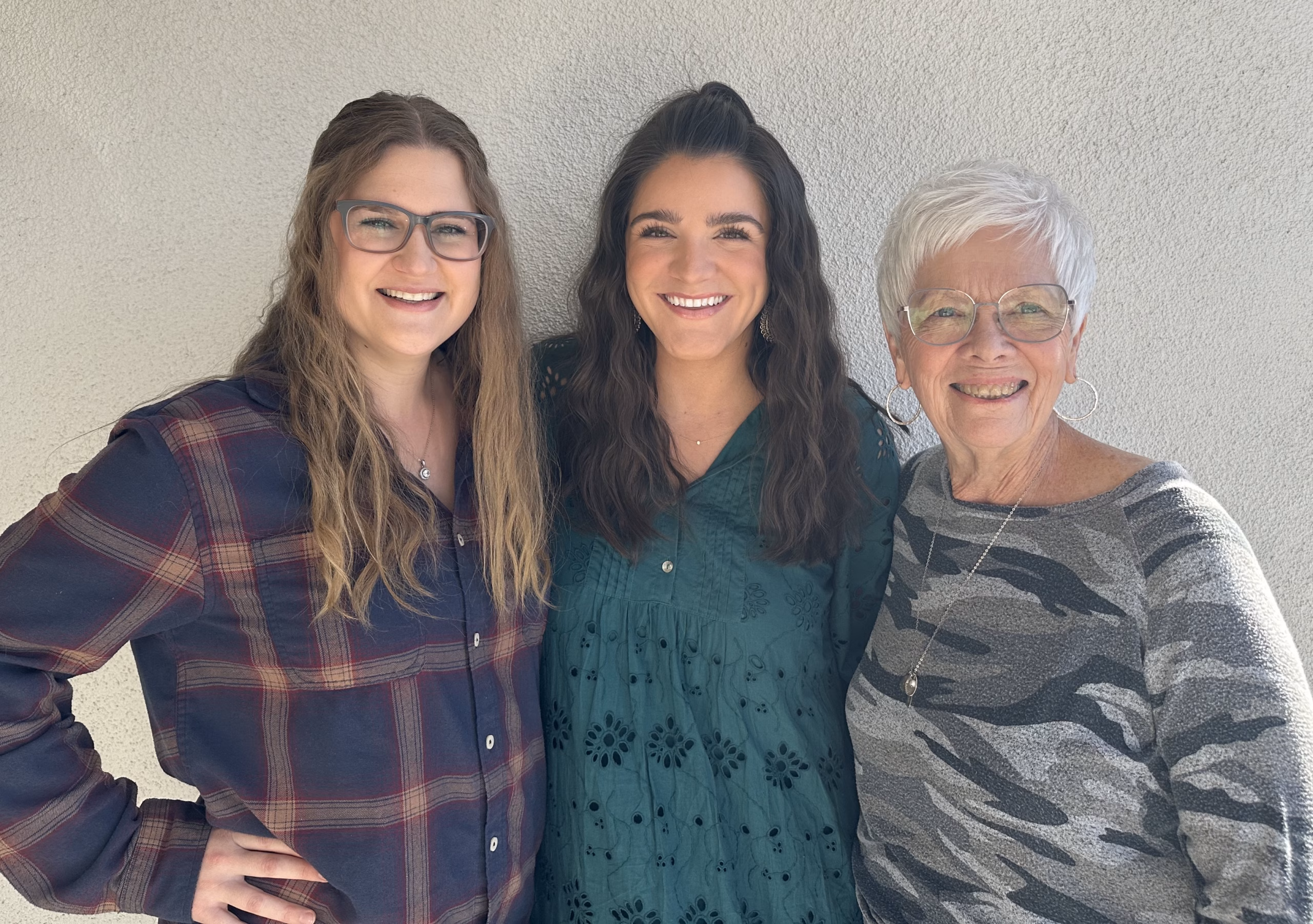 Worship Team Three women standing side-by-side smiling at the camera.